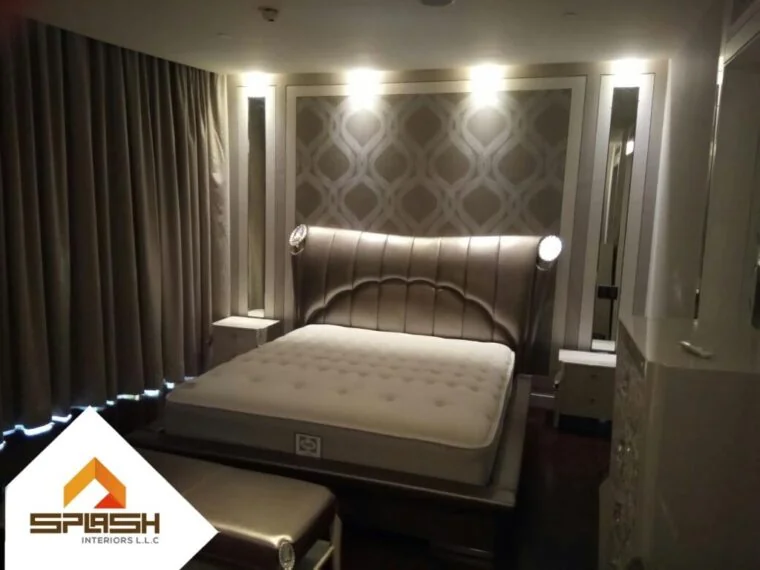 Bedroom with upholstered headboard and wall finishes