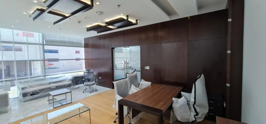 Office with meeting table and timber wall